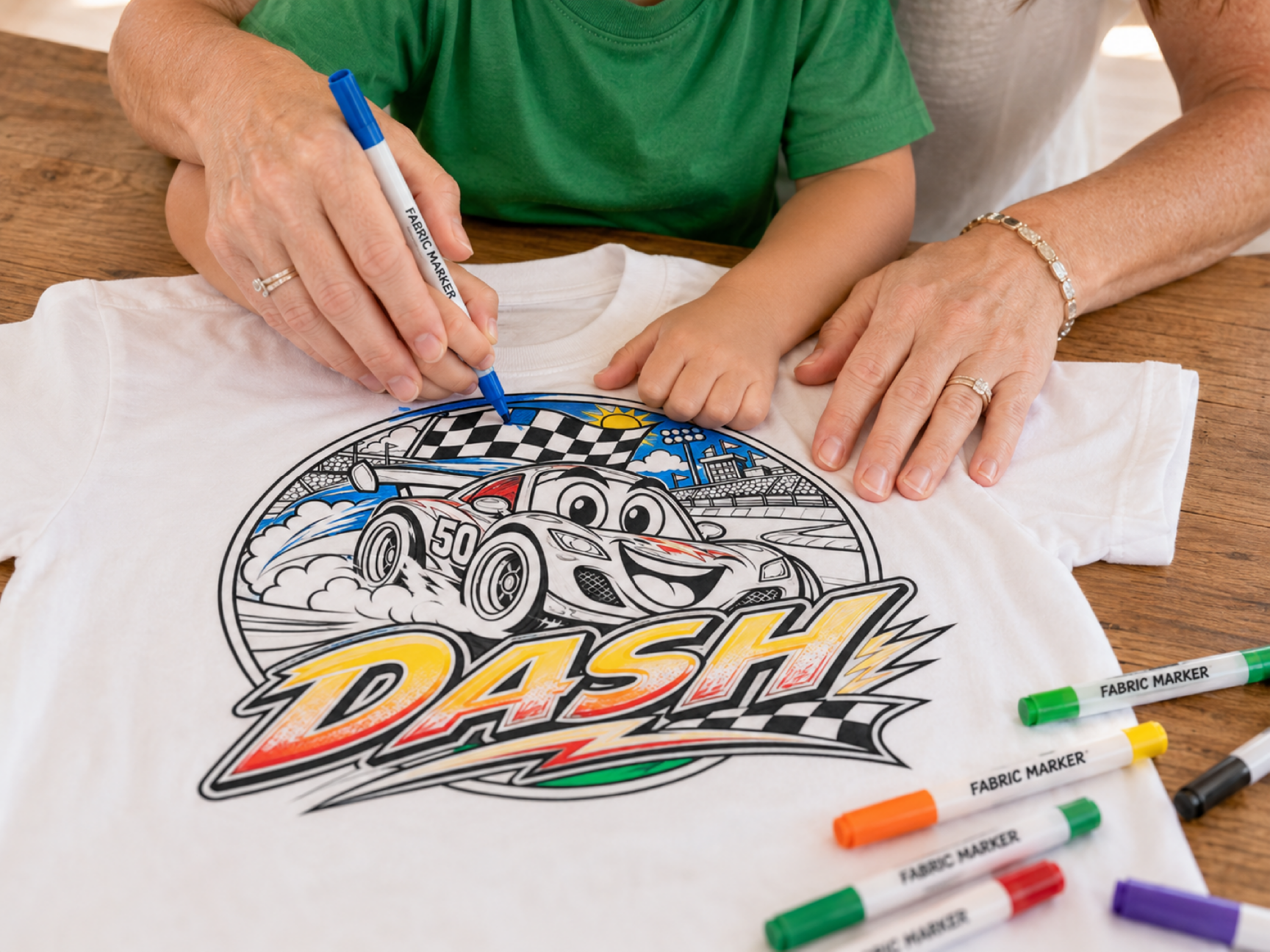 A child and Stephanie coloring a DASH MarkerMade shirt together with fabric markers.